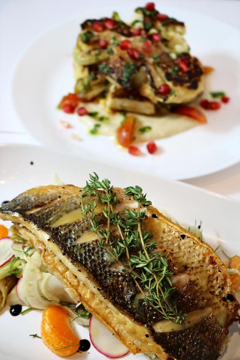 Plated dinner service with gourmet dishes and skyline views at Highwater Rooftop catering event